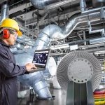 Engineer using laptop computer for maintenance in thermal power plant industrail